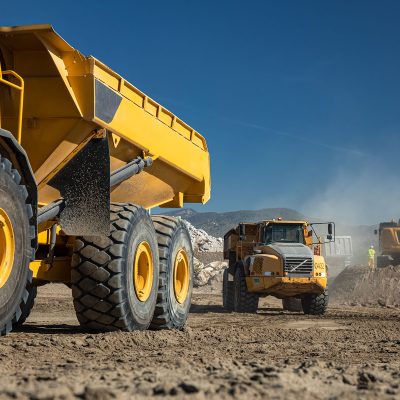 Industrial dumper trucks working on a construction in Malaga city -  Digging and moving sand with large dumper truck - heavy machinery activity at the construction site